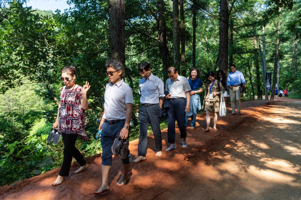 Barefoot walking event on an ocher road in Gyejok mountain, Daejeon during the 86th international conference in Daejeon